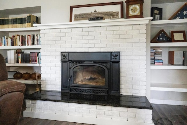 room details with hardwood / wood-style flooring and built in shelves