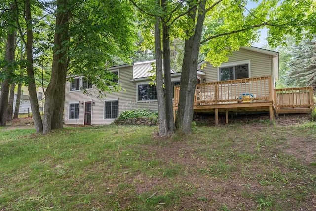 back of property featuring a yard and a deck