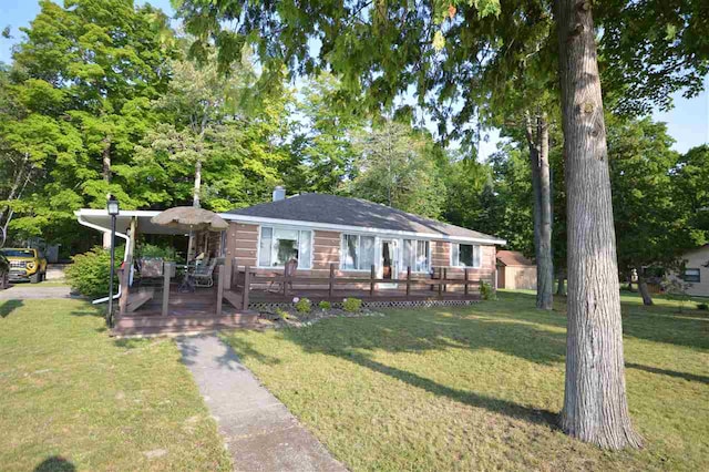 ranch-style home with a wooden deck and a front lawn