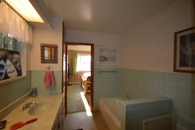 bathroom featuring vanity, tile walls, baseboard heating, and a tub to relax in