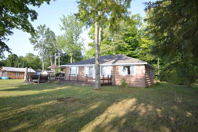 exterior space with a wooden deck and a yard