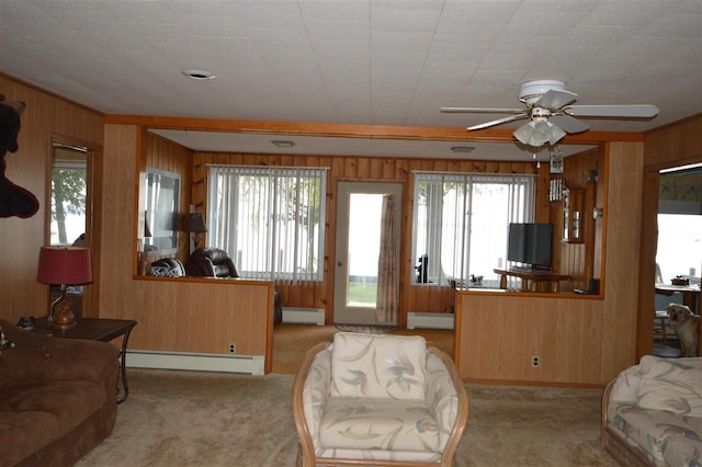 carpeted living room with a healthy amount of sunlight, a baseboard radiator, and ceiling fan