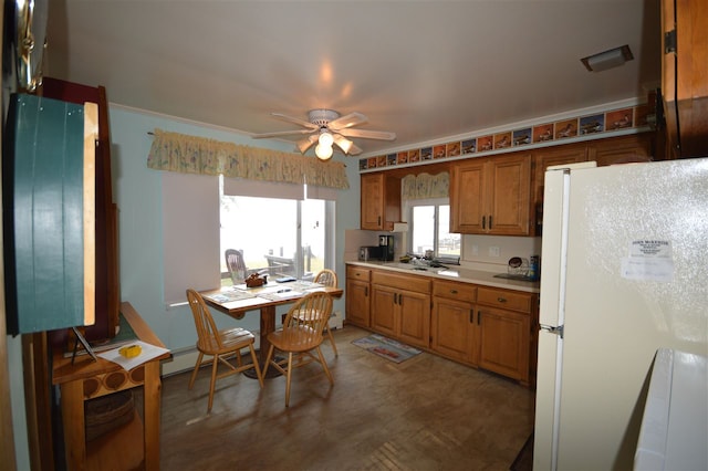 kitchen with sink, white fridge, and ceiling fan