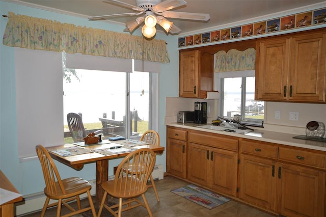 kitchen featuring sink, light tile patterned floors, and ceiling fan