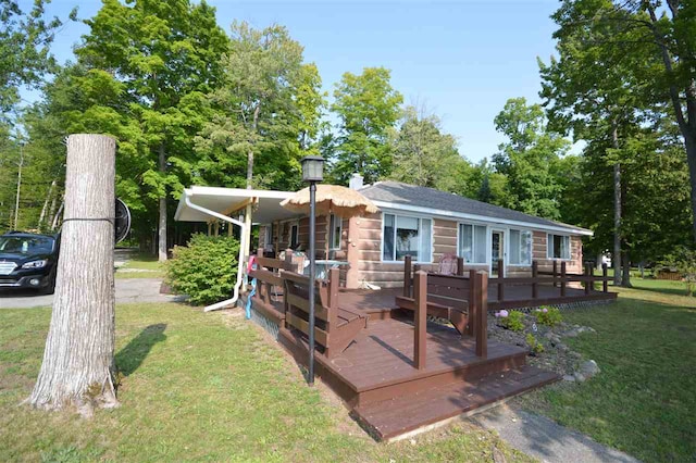 view of front facade with a deck and a front lawn