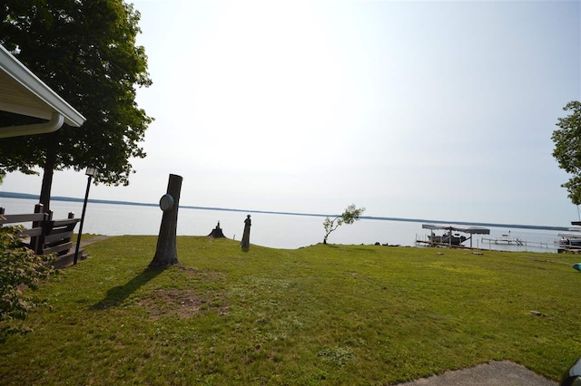 view of yard featuring a boat dock and a water view