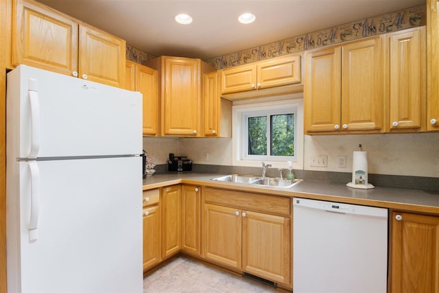 kitchen featuring light tile patterned floors, white appliances, and sink