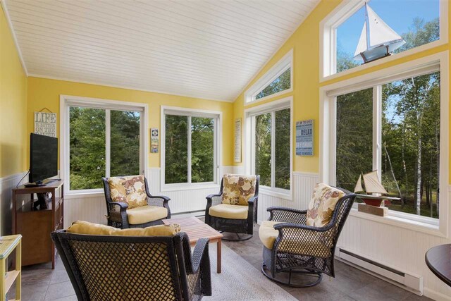 sunroom featuring baseboard heating, a healthy amount of sunlight, and lofted ceiling