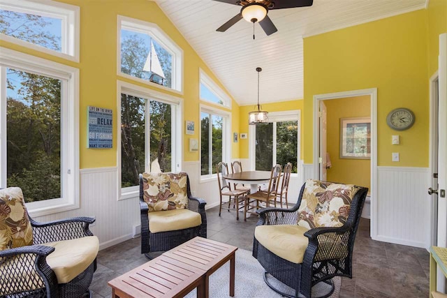 sunroom / solarium featuring ceiling fan and vaulted ceiling