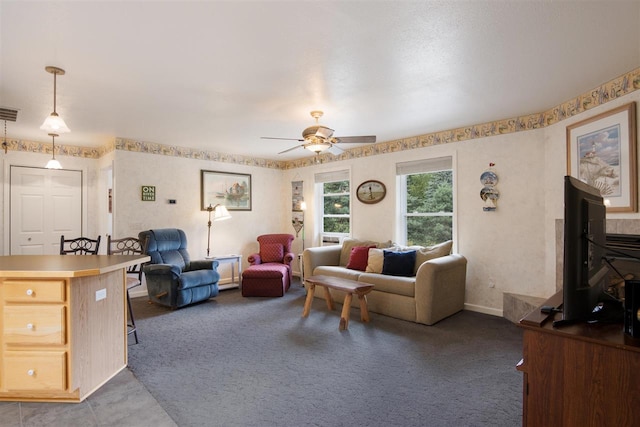 carpeted living room with ceiling fan