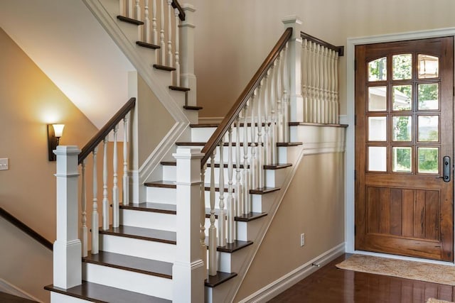 stairs featuring wood finished floors