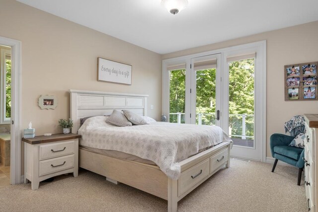 bedroom featuring light colored carpet, access to outside, and multiple windows