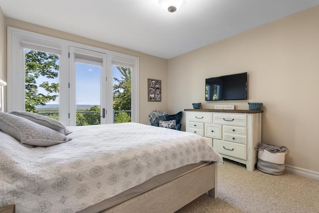 bedroom featuring light carpet, access to outside, and baseboards