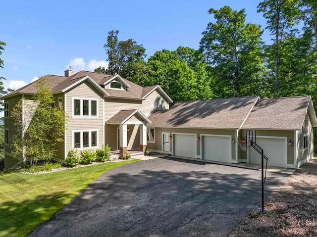 view of front of home featuring a garage and a front lawn