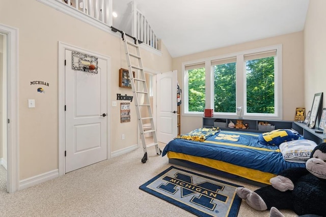 bedroom with carpet, lofted ceiling, and baseboards