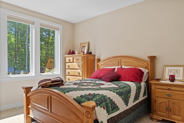 bedroom with carpet flooring and baseboards