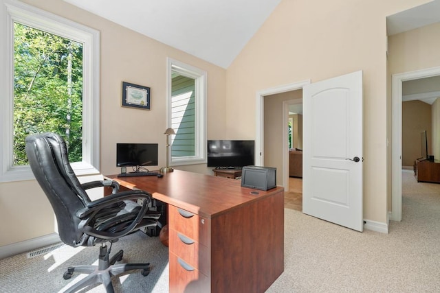 home office featuring vaulted ceiling, baseboards, visible vents, and light colored carpet