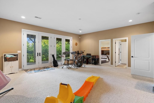 interior space featuring light carpet, recessed lighting, visible vents, and french doors