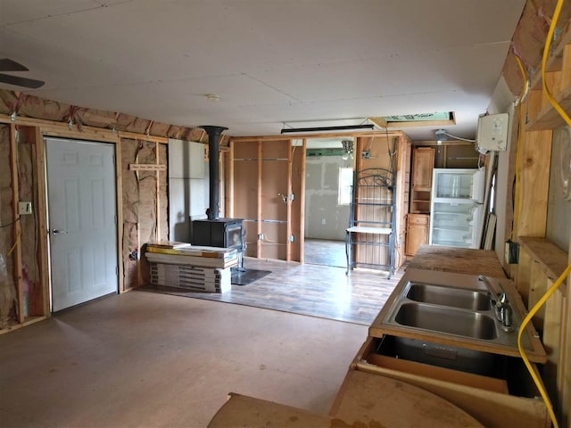 basement with a wood stove and sink