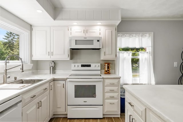 kitchen with sink, light wood-type flooring, white appliances, and white cabinets