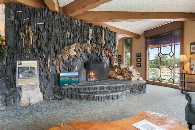 living room with beam ceiling, a textured ceiling, and carpet