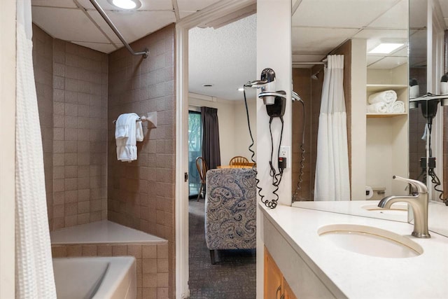 bathroom with vanity, a paneled ceiling, and shower / bath combo