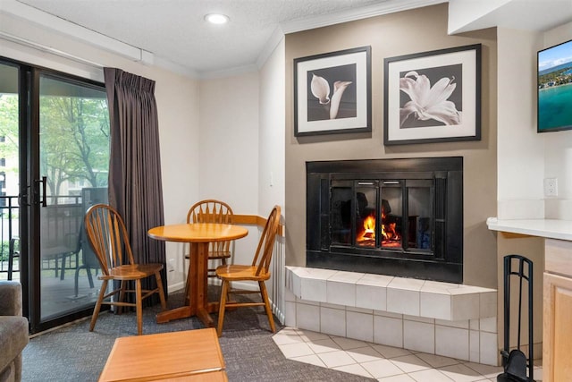 interior space featuring a fireplace, a textured ceiling, and ornamental molding