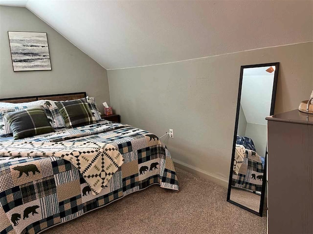 bedroom with vaulted ceiling and carpet flooring