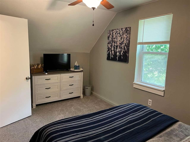 carpeted bedroom with ceiling fan and vaulted ceiling