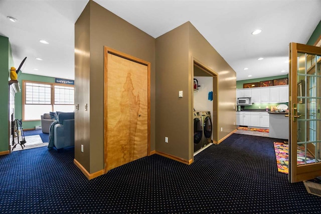 hall with recessed lighting, baseboards, separate washer and dryer, and dark carpet