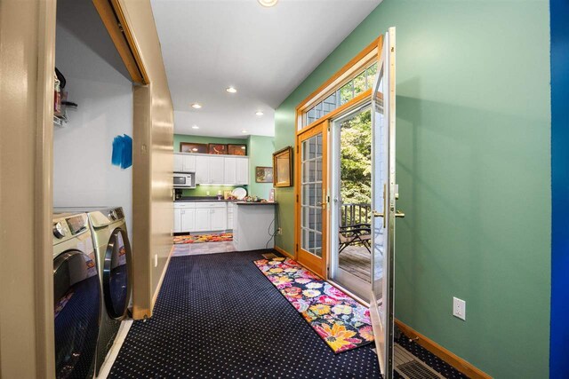 hallway with a healthy amount of sunlight and carpet