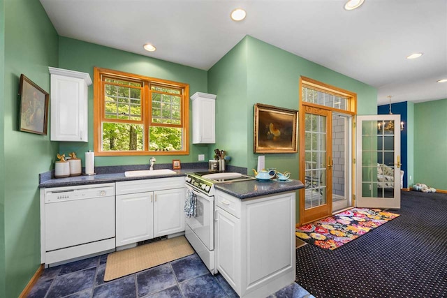 bathroom featuring tile patterned flooring, toilet, a relaxing tiled tub, and vanity