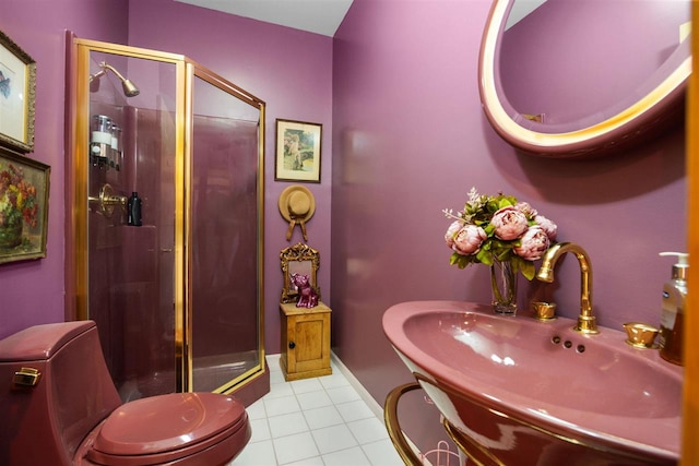 full bath with a sink, baseboards, a shower stall, and tile patterned floors