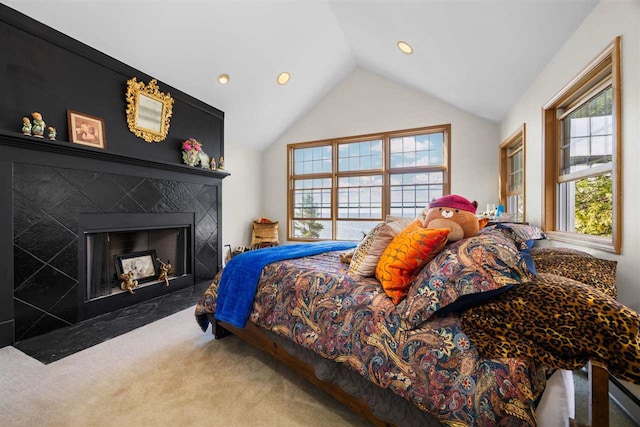 bedroom featuring lofted ceiling, carpet flooring, recessed lighting, and a high end fireplace