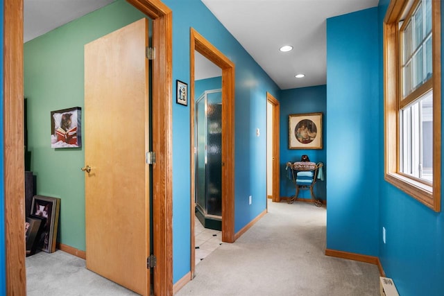 corridor featuring a baseboard heating unit, carpet flooring, recessed lighting, and baseboards