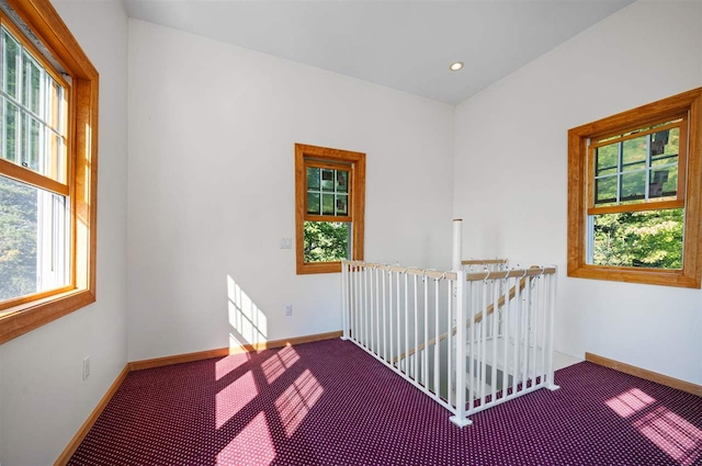 carpeted spare room featuring recessed lighting and baseboards