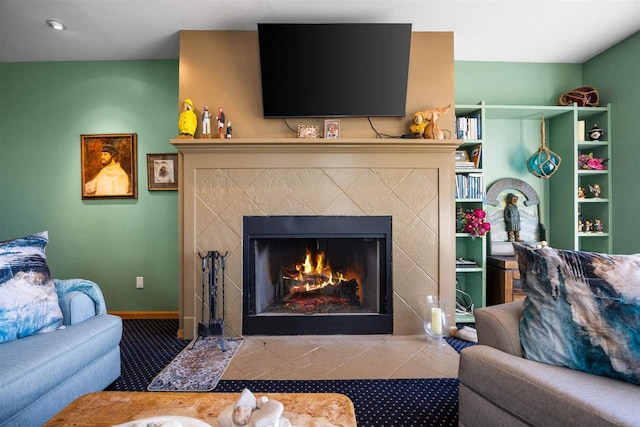 living room featuring a tile fireplace