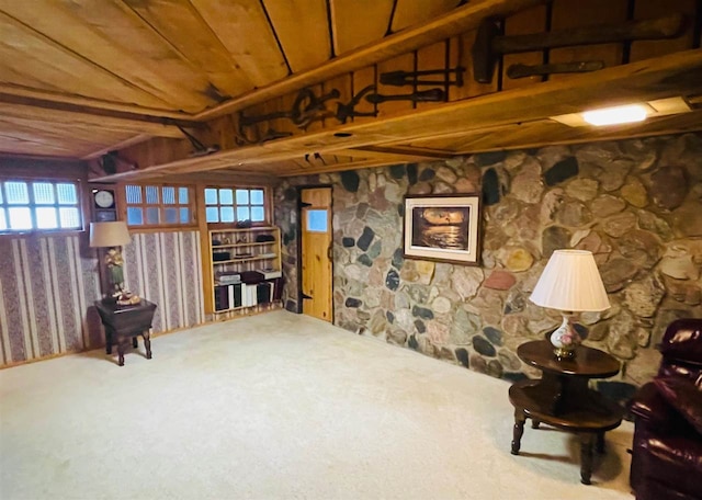 living area with wooden ceiling, plenty of natural light, and carpet floors