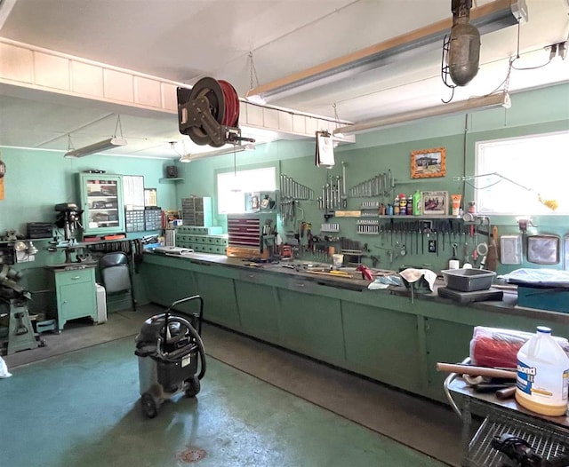 interior space featuring green cabinetry and concrete floors