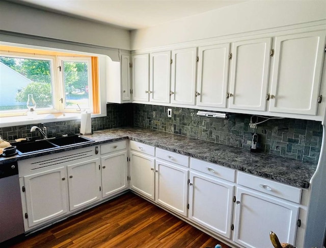 kitchen featuring dishwasher, dark wood-type flooring, tasteful backsplash, and white cabinetry