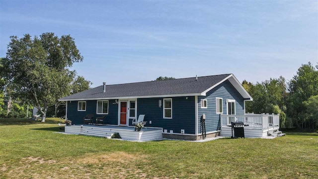 view of front of house with a front lawn and a deck