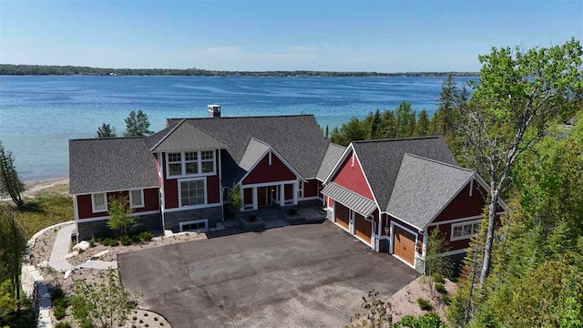 birds eye view of property with a water view