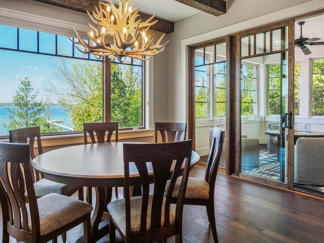 11305 Evergreen Ln, Charlevoix, MI 49720 - dining room featuring a chandelier, wood finished floors, and beam ceiling