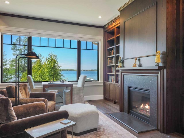 11305 Evergreen Ln, Charlevoix, MI 49720 - living room with plenty of natural light, a glass covered fireplace, wood finished floors, recessed lighting, and ornamental molding