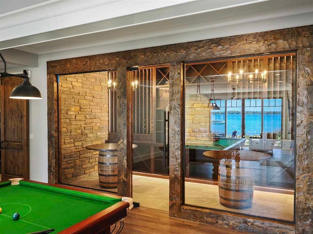 11305 Evergreen Ln, Charlevoix, MI 49720 - rec room featuring wood finished floors, a chandelier, billiards table, and a water view