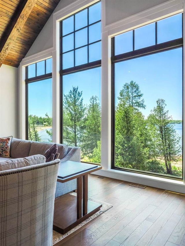 11305 Evergreen Ln, Charlevoix, MI 49720 - living room with wood ceiling with exposed beams, wood finished floors, and high vaulted ceiling