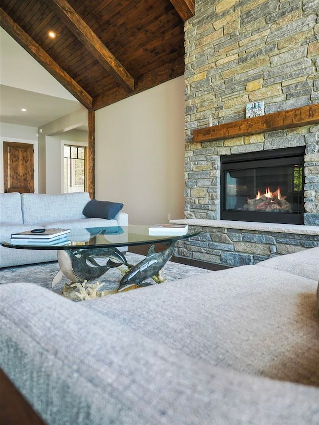 living room with beam ceiling, high vaulted ceiling, a stone fireplace, and wood ceiling