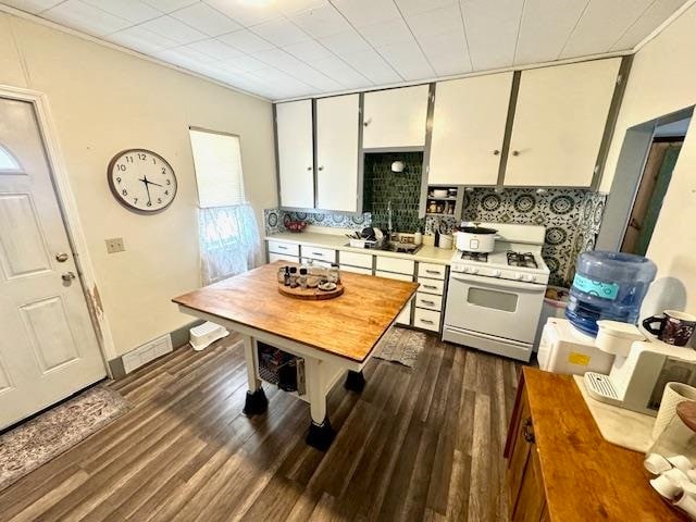 kitchen with backsplash, white cabinetry, dark hardwood / wood-style flooring, and white range with gas cooktop