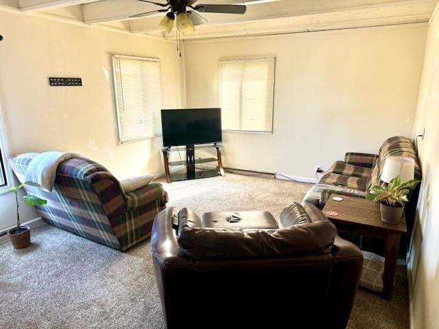 carpeted living room with ceiling fan and beamed ceiling