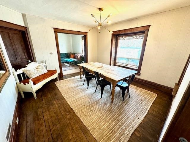 dining room with an inviting chandelier and wood-type flooring